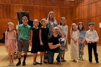 a group of children and adults posing for a photo